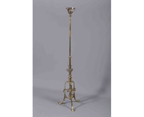 A GOOD LATE 19TH CENTURY BRASS TELESCOPIC STANDARD LAMP, now with fitting for electricity, raised on a pierced and cast tripo