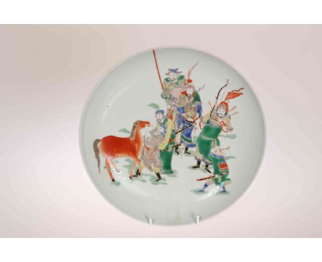 A CHINESE FAMILLE VERTE DISH, enamel painted with soldiers and a horse, six character mark. 27cm
