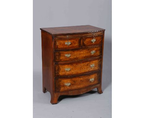 A GEORGIAN STYLE BURR WALNUT BOW FRONTED CHEST OF DRAWERS, the crossbanded top with reeded edge over a slide above two short 