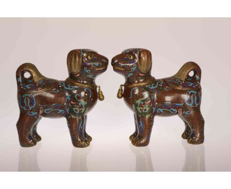 A PAIR OF CHINESE CLOISONNE ENAMEL CENSERS IN THE FORM OF DOGS, probably late 19th or early 20th Century, each modelled stand