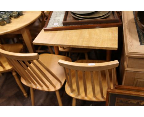 Long light oak kitchen table and 4 stick back light wood chairs
