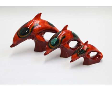 Set of 3 Poole Pottery delphis dolphins, the larger one has a slight crack under the beak