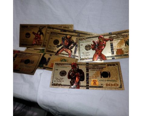Eight gold plated Marvel novelty bank notes to include Hulk, Ironman and Deadpool issues. UK P&amp;P Group 0 (£6+VAT for the 