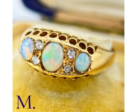 An Antique Opal and Diamond RingThe 18ct yellow gold ring is set with three good colour opals with four accent rose cut diamo