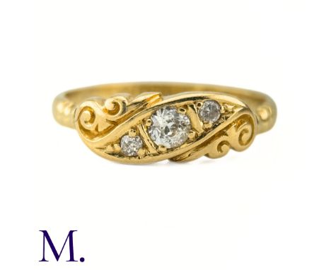 An Antique Diamond Gypsy RingThe antique 18ct yellow gold carved ring is set with three old cut diamonds, the centre stone of