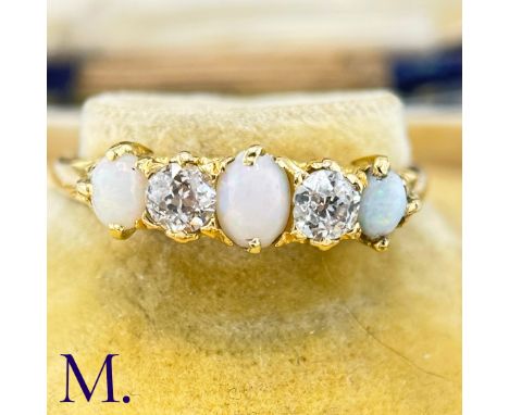 An Antique Opal and Diamond RingThe 18ct yellow gold ring is set with three oval opals with good colour and two 0.15ct old cu