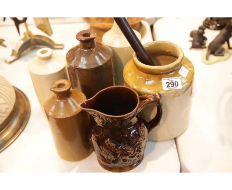 Collection of vintage stoneware jars and containers plus a treacle glazed hunting scene jug and a fisherman's wooden priest. 