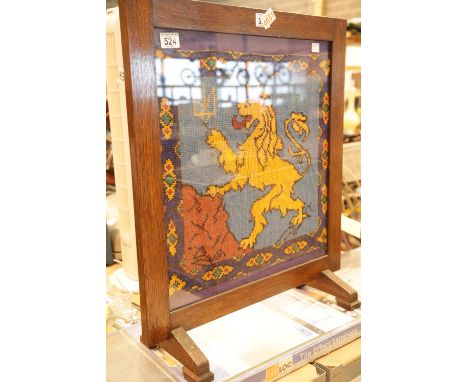 Glazed oak firescreen with woolwork crowned lion. This lot is not available for in-house P&amp;P. 