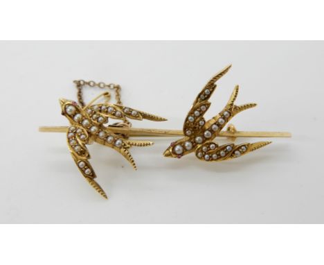 A 15ct gold pearl set swallows brooch with ruby eyes, 5.5cm x 2.5cm approx, weight 6.9gms Condition Report: Light general wea