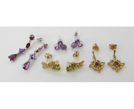 A pair of 9ct gold peridot and diamond earrings, diamond and garnet earrings and two pairs of white 9ct gold amethyst earring