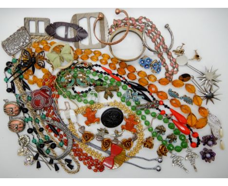 A collection of vintage costume jewellery to include, two carved orange Lucite frog clips, a Trifari white elephant necklace,