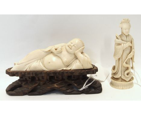 A Chinese early 20th Century carved ivory reclining Buddha, on wood stand, 13cm wide and an ivory Empress chess piece, 10.3cm