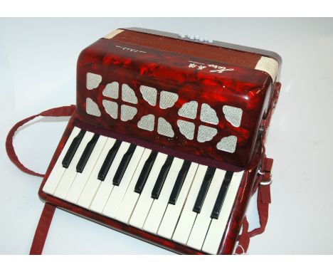 A Chinese accordion on original box Condition Report: Available upon request
