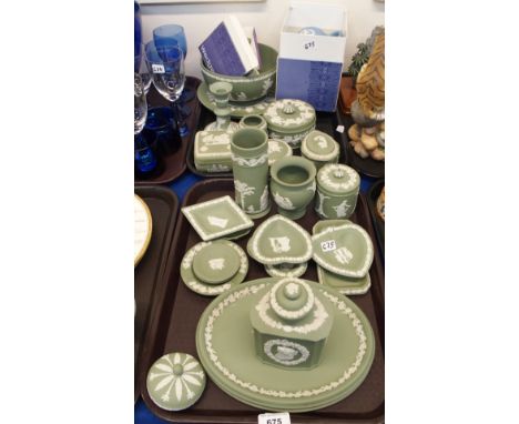 A collection of Wedgwood green jasperware including a tea caddy, 16.5cm high, two oval dishes, candlestick, powder bowl, trin