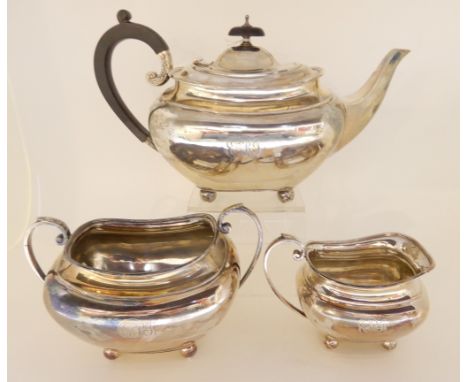 A three piece silver tea service by James Dixon and Sons, Sheffield 1906, of rounded rectangular form on four ball feet, each