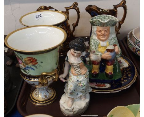 A pair of 19th Century English porcelain urn shaped vases, handpainted with flowers on a light green ground, with cobalt blue