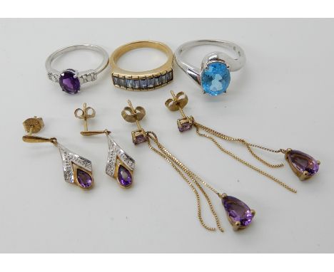 A 9ct blue topaz ring size R1/2, a 9ct blue gem ring N1/2, two pairs of amethyst drop earrings and an amethyst silver ring si
