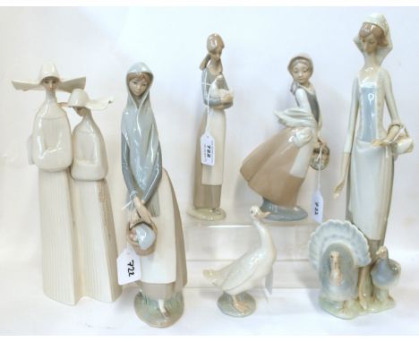 Three Lladro figure groups to include pair of nuns, 33.5cm high, woman with two turkeys and woman with basket of apples and t