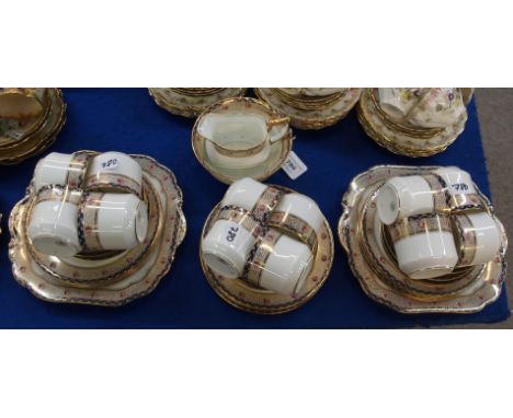 An Aynsley teaset, decorated with a band of pink roses on a cracked gilt and blue ground comprising; twelve cups and saucers,