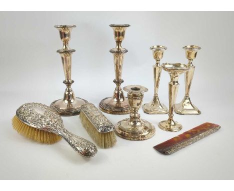 A silver back hairbrush, comb and clothes brush set; a pair of silver loaded candlesticks, a single silver loaded candlestick