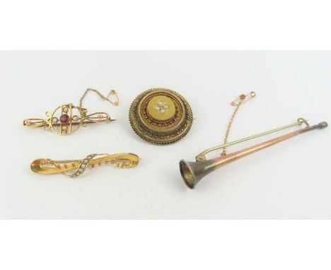 An early 20th century 9ct gold bar brooch set with split pearls; another brooch from a similar period; A Victorian round broo