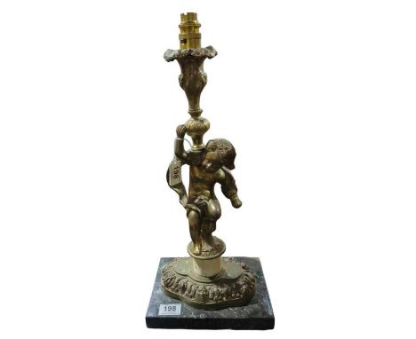 A decorative gilt metal table lamp cast as a putto supporting a torch, on pedestal and mounted on rectangular marble base, 46