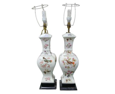 A pair of large decorative ceramic table lamps with flower and songbird decoration, 53cms high