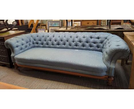 A Victorian Chesterfield settee with light blue damask upholstery, button back and on turned supports