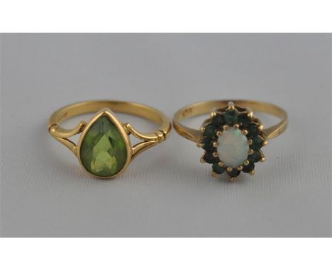 An 18ct. gold and peridot ring, having pendeloque set peridot, stamped 18ct. (3.8g), together with a 9ct. gold ring, set oval