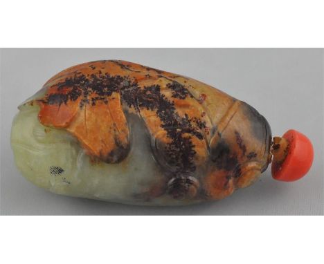 A Qing dynasty russet jade pebble snuff bottle, depicting a mythical beast.7cm long