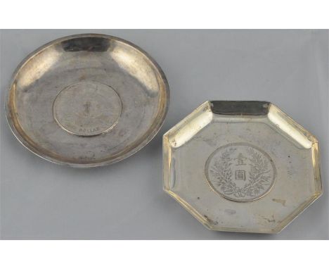 Two Chinese silver coin dishes, one of hexagonal form and stamped "sterling" to base, the other of circular form, (white meta