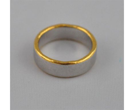 A platinum band, having gold accents to rim, purchased from Electrum Gallery, South Molton Street, known for its contemporary