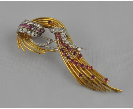 A yellow metal, diamond and ruby set scroll brooch, the shaped yellow metal wire back having applied white metal&nbsp;set rou