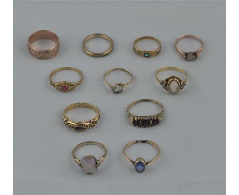 A collection of eleven various gold and yellow metal rings, to include; a yellow metal and solitaire diamond ring, set rose c