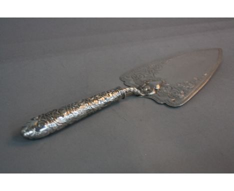 A VICTORIAN SILVER TROWEL, the blade engraved with a border of discs surrounding foliate scrolls, cast silver handle, maker C