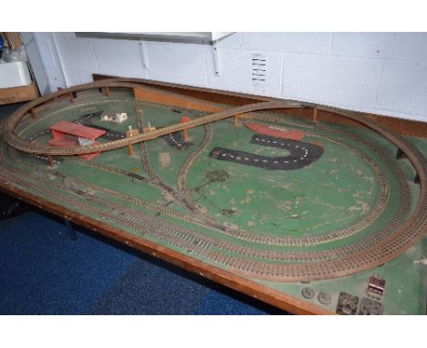 A OO GAUGE THREE RAIL MODEL RAILWAY LAYOUT, comprising two ovals and figure of eight track layout, with some remaining buildi