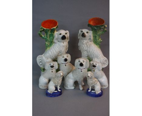A PAIR OF VICTORIAN SEATED SPANIEL SPILL VASES, (restored), heights approximately 34cm, together with three pairs of late 19t