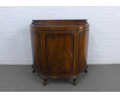 Mahogany bow front cabinet with a ledgeback, single door and shelved interior, on cabriole legs with claw and ball feet, 109 