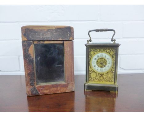 Brass cased carriage clock, the brass dial with flowers and foliage, Arabic numerals ti the enamel chapter ring, with leather