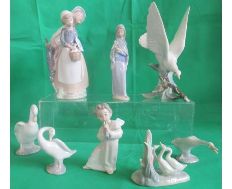 A collection of eight various Lladro and Nao figurines.