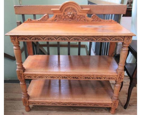 An Edwardian carved oak three tier buffet.