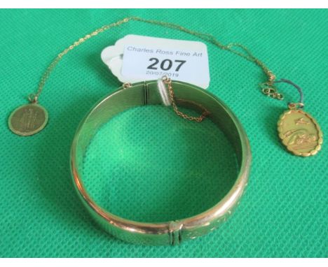 A 9ct gold bangle, part foliate engraved in 9ct gold St Christopher charm pendant and chain, together with another.