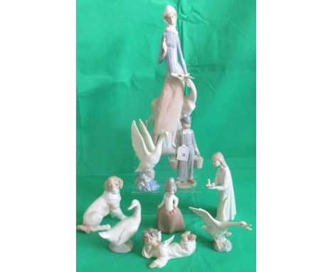 A collection of nine various Lladro and Nao figurines, to include: an angel, three ducks, a dog and other related items.