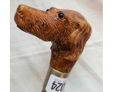 A carved wood walking stick with a push button that opens mouth 