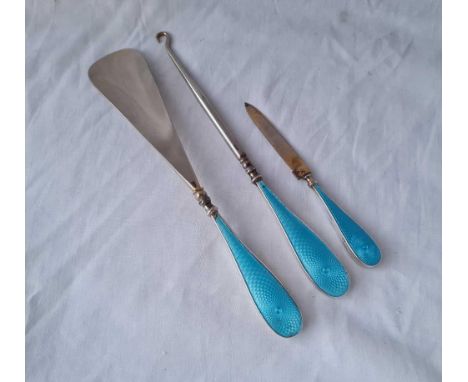 Three silver and enamel decorated items (button hook, shoe horn etc.)