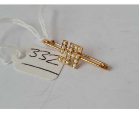 A gold and pearl swastika brooch - 1.1 gms 