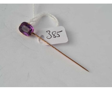 A gold mounted amethyst stick pin