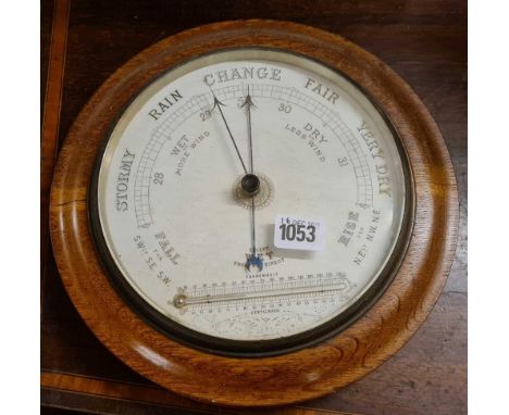 A circular barometer or thermometer - 10" wide