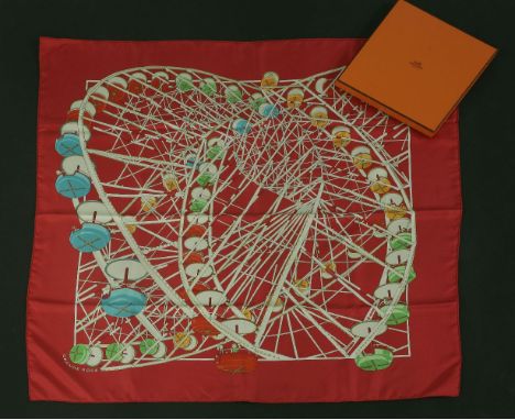 An Hermès silk scarf,'Grande Roue', designed by Dmitri Rybaltchenko, red ground with a printed geometric fairground ride sign