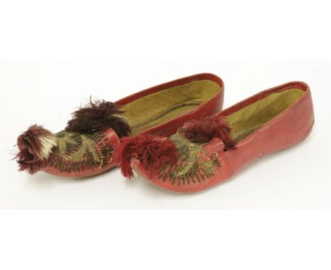 A pair of vintage Moroccan red leather cherbil metal embroidered shoes,with pompom detail to toe, with leather sole (2)